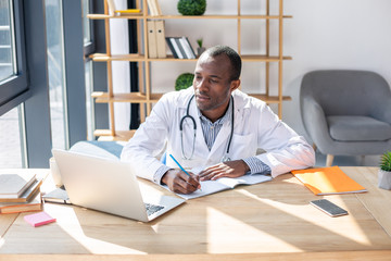 Attentive international male person completing task