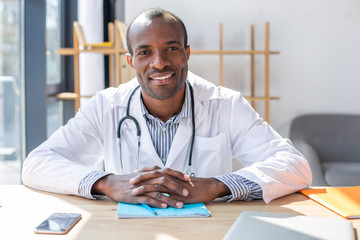 Portrait of delighted man that sitting at workplace