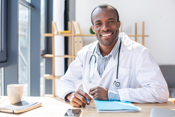 Handsome practitioner posing on camera