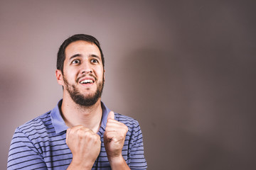 Handsome man with beard making surprise gesture