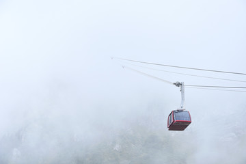 View of cableway gondola cable car funicular on cloudly sky background