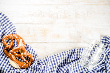 Oktoberfest food menu, bavarian pretzels with beer bottle mug, white wooden background copy space...