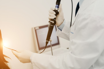 The otolorinologist conducts manipulations to investigate the diseases of the nose with the help of...
