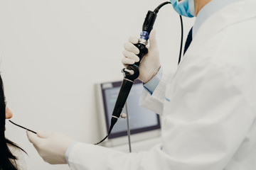 The otolorinologist conducts manipulations to investigate the diseases of the nose with the help of...
