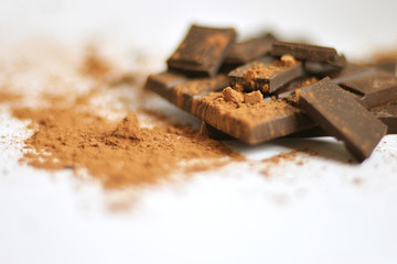 Chocolate on a white background. Bitter chocolate and cocoa. Still life with chocolate.