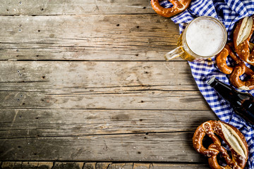 Oktoberfest food menu, bavarian pretzels with beer bottle mug on old rustic wooden background, copy...