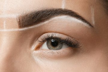 Obraz premium Young woman before procedure of eyebrows permanent makeup, closeup