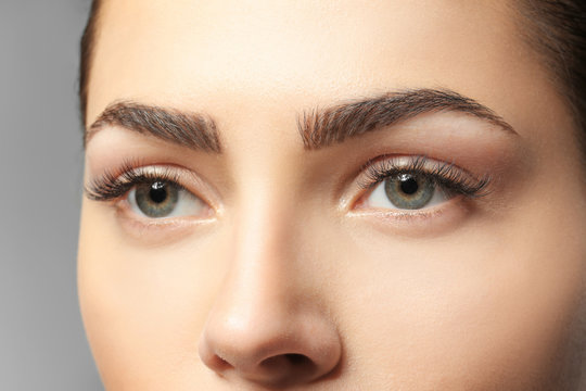 Naklejki Young woman with beautiful eyebrows, closeup