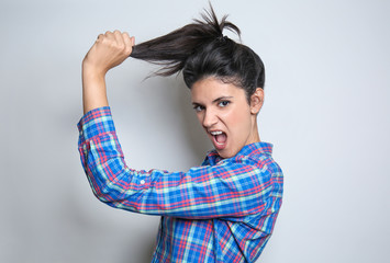 Fototapeta premium Attractive young woman posing on light background