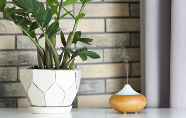 Aroma oil diffuser on table at home. Air freshener