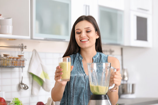 Young woman with tasty healthy smoothie in kitchen