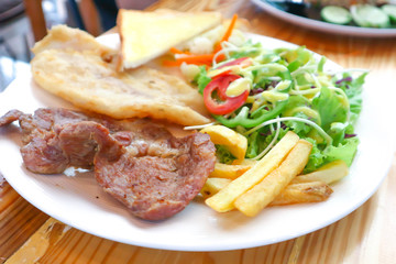 pork steak and fish steak with salad