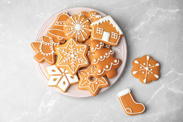 Plate with tasty homemade Christmas cookies on table, top view