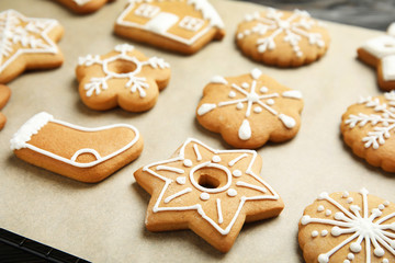 Obraz na płótnie Canvas Tasty homemade Christmas cookies on parchment paper, closeup