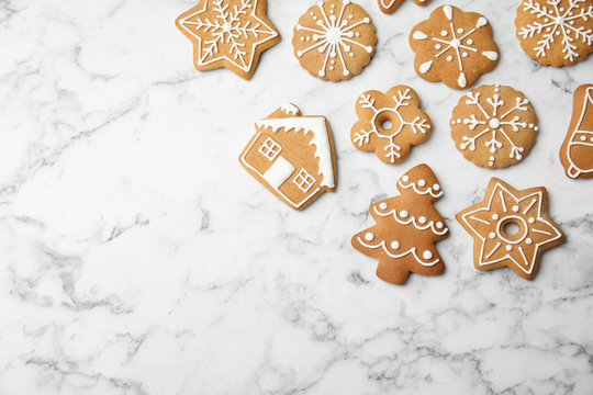 Tasty homemade Christmas cookies on marble background, top view