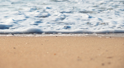 Wave and sand as a background. Beautiful natural composition at the summer time