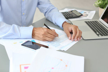 Tax accountant working with documents at table