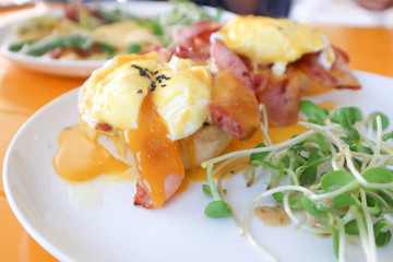 egg benedict or bread with bacon and poached egg