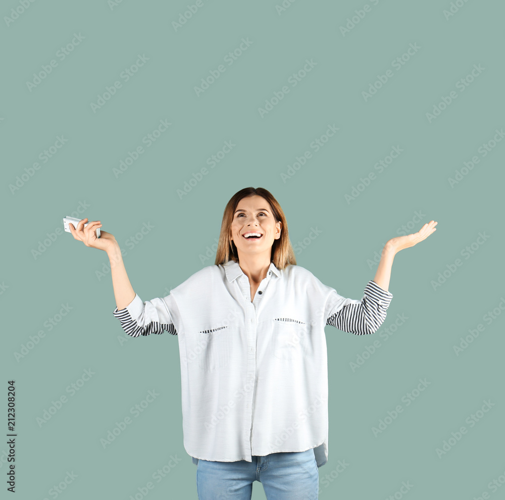 Canvas Prints happy woman with air conditioner remote on color background