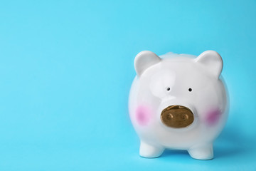 White piggy bank on color background. Money saving