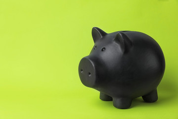 Black piggy bank on color background. Money saving