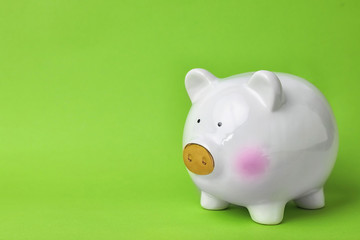 White piggy bank on color background. Money saving