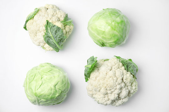 Flat lay composition with ripe cabbages on white background
