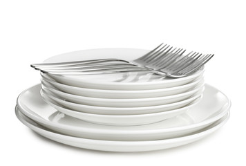 Stack of ceramic dishware with cutlery on white background