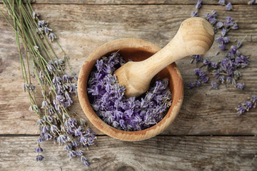 Mortar with lavender flowers on table, top view. Ingredient for natural cosmetic