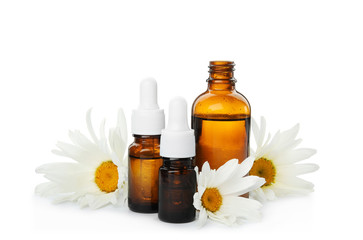 Composition with essential oil and flowers on white background