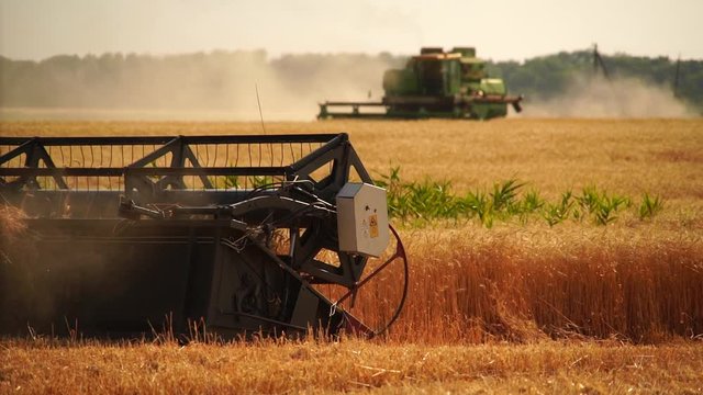 Close up of combine harvester for harvesting wheat. Slow motion