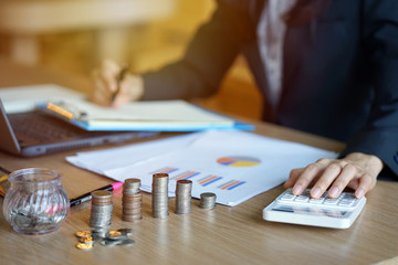 Young entrepreneurs are, Account Officer, Bank officer  using the calculator. Savings, finances and...