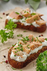 Sandwich with smoked salmon, cream cheese, spices and greens