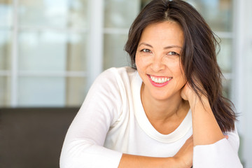 Portrait of an Asian woman smiling.