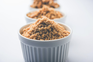 Crushed peanuts or mungfali powder with whole and roasted groundnut. Served in a bowl over moody background. Selective focus