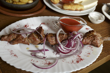 Meat, grilled on skewers, Pork with pickled onion, Shot of dinner in Restaurant.