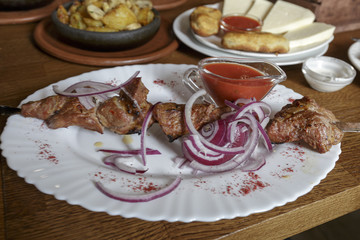 Meat, grilled on skewers, Pork with pickled onion, Shot of dinner in Restaurant.