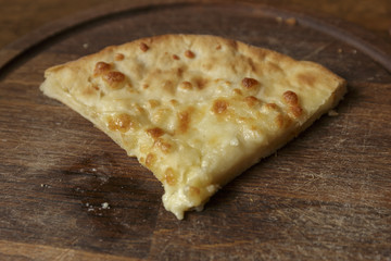Slice of fresh cheese pizza in a plate on the table, Italian traditional appetizer, high angle view.
