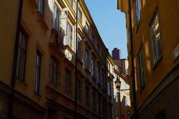 Fototapeta na wymiar Sunlight and shadows in the narrow street in Stockholm, Sweden
