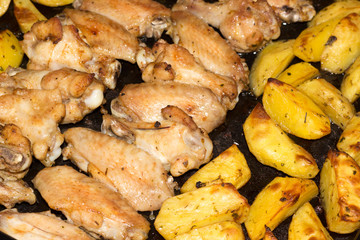 chicken wings with potatoes in the oven