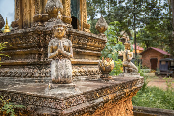 Fototapeta na wymiar detail of decorative ornaments of golden stupa in buddhist temple in cambodia