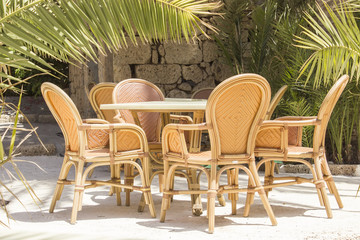 Fototapeta na wymiar Empty Lunch table with chairs outdoor. Palms over and nobody