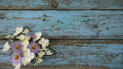 Blue wooden Board with flowers in the corner