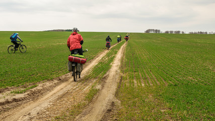 Bicyclists in roughed field in Nizhny Novgorod Region, Russia