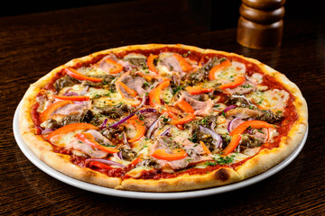 Tasty warm pizza with bacon, pepper, cheese and onion on the tab