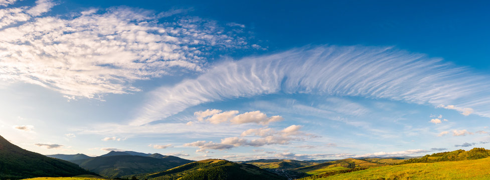 gorgeous evening clouds over the mountains. lovely panorama of striking cloudscape on a blue sky