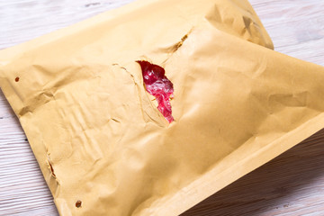 Damaded brown paper padded envelope.