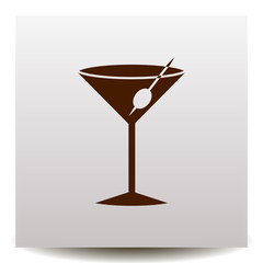 A glass icon with a cocktail and olive on a realistic paper background with shadow