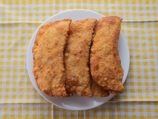 many fried pies on a white plate