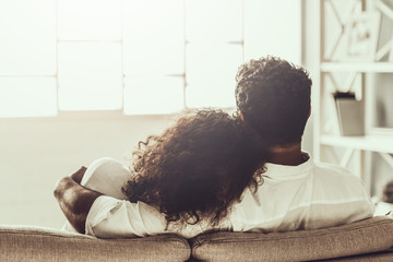 Young Pakistani Couple Sitting on Sofa and Hugging